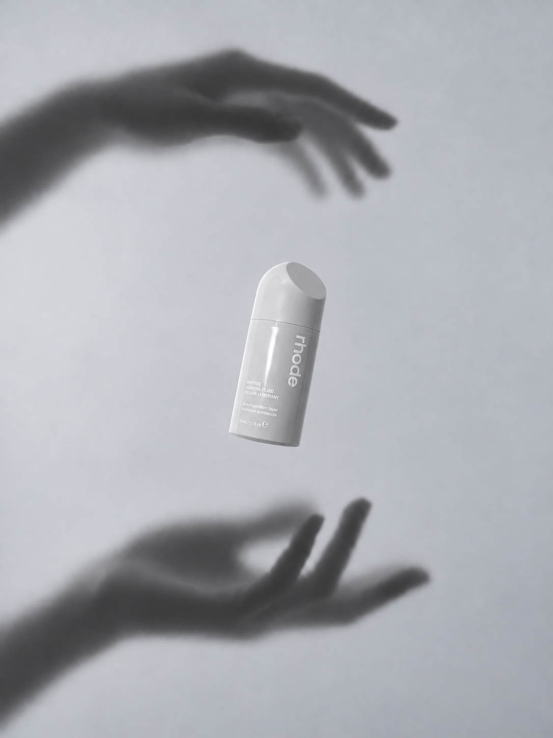 Floating direction — the same skincare fluid bottle