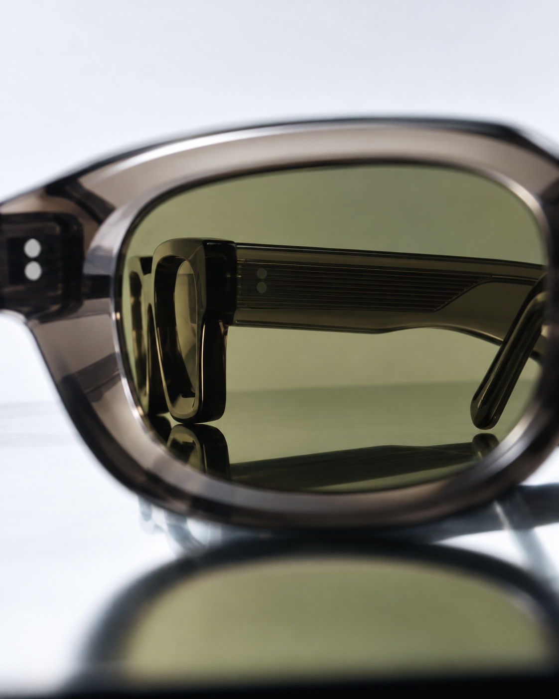 Sunglasses campaign visual — macro detail with a reflection in the lens